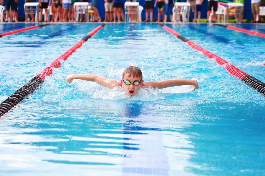 child swimming in recreation center