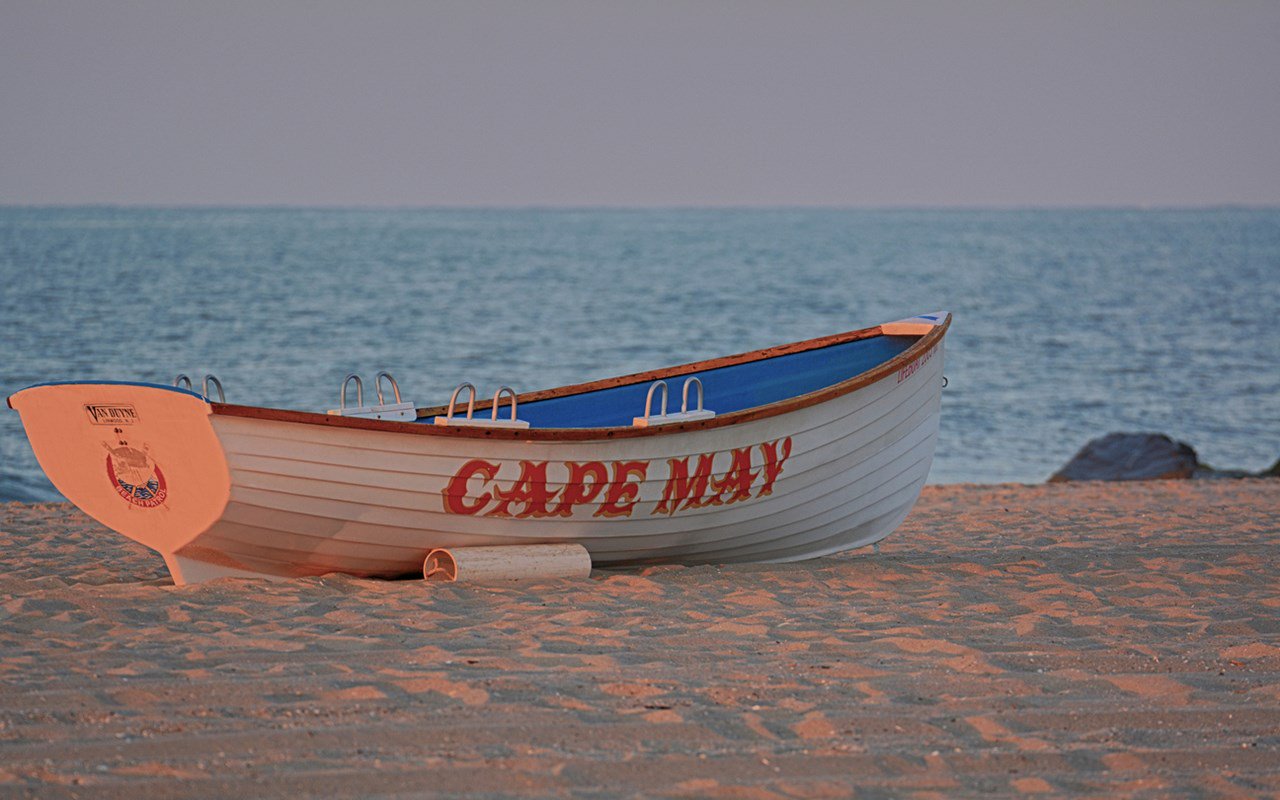 Unsplash_Camp _May small boat on sand